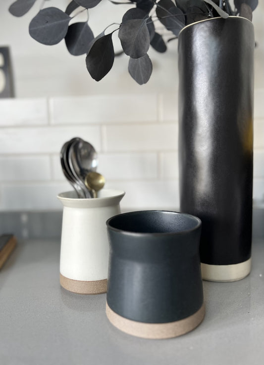 Black ceramic vase with cream band base